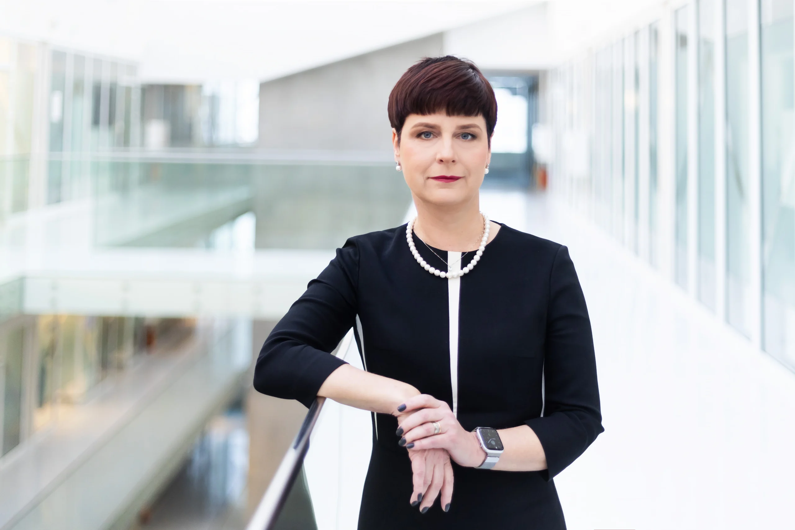 Edita Gimžauskienė, Vice‑Rector of Strategic Partnerships at KTU, standing in modern university interior.