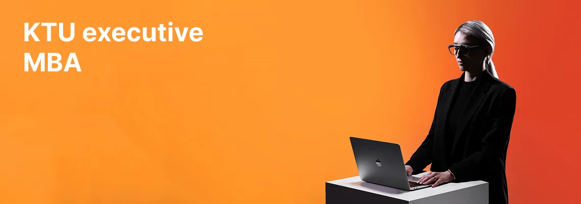 A KTU School of Economics and Business student working on a laptop against an orange decorative background. The faculty offers KTU MBA studies for executives. Choose KTU MBA.